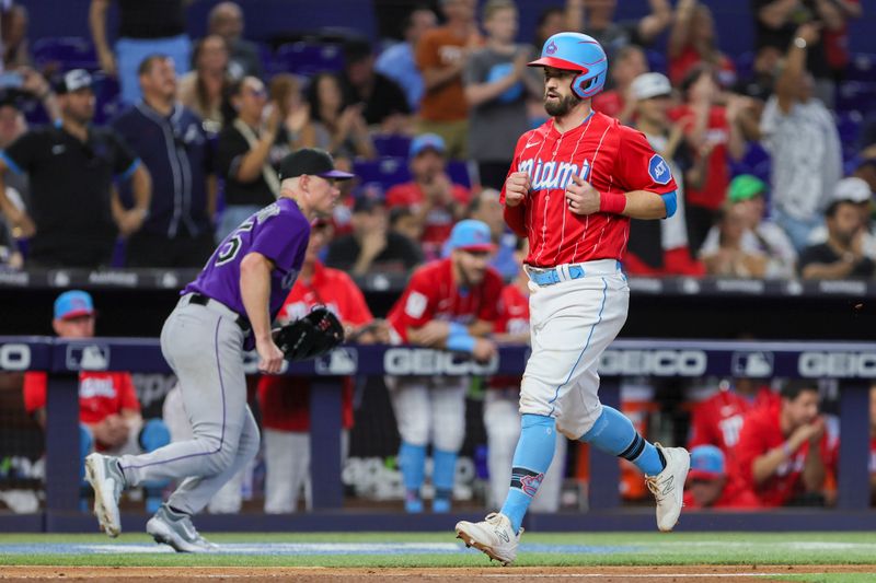 Jul 22, 2023; Miami, Florida, USA; Miami Marlins left fielder Jon Berti (5) scores after an RBI triple from second baseman Luis Arraez (not pictured) against the Colorado Rockies during the fifth inning at loanDepot Park. Mandatory Credit: Sam Navarro-USA TODAY Sports