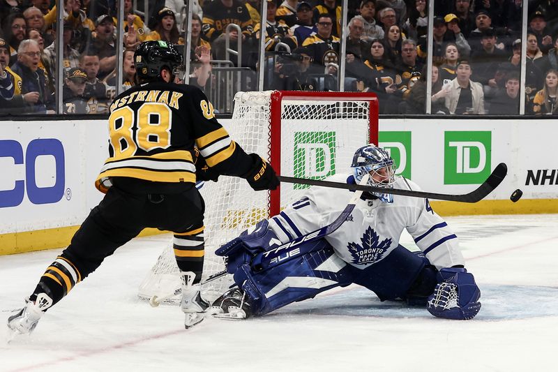 Mar 24, 2026; Boston, Massachusetts, USA; Boston Bruins right wing David Pastrnak (88) reaches for a rebound in front of Toronto Maple Leafs goaltender Anthony Stolarz (41) during the second period at TD Garden. Mandatory Credit: Winslow Townson-Imagn Images