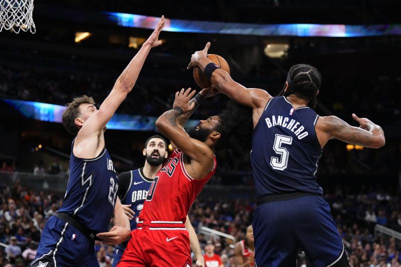 ORLANDO, FLORIDA - FEBRUARY 10: Paolo Banchero #5 of the Orlando Magic blocks the shot of Coby White #0 of the Chicago Bulls during the fourth quarter at Kia Center on February 10, 2024 in Orlando, Florida. NOTE TO USER: User expressly acknowledges and agrees that, by downloading and or using this photograph, user is consenting to the terms and conditions of the Getty Images License Agreement. (Photo by Rich Storry/Getty Images)