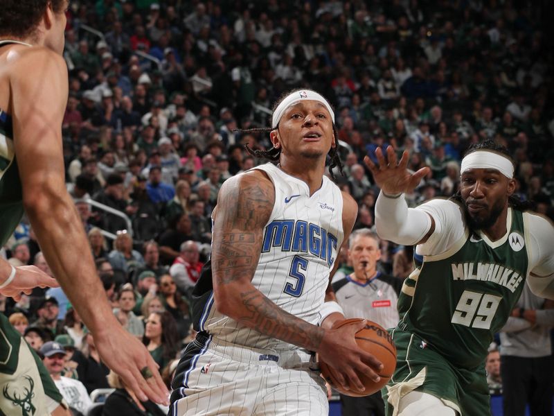 MILWAUKEE, WI - APRIL 10: Paolo Banchero #5 of the Orlando Magic drives to the basket during the game against the Milwaukee Bucks on April 10, 2024 at the Fiserv Forum Center in Milwaukee, Wisconsin. NOTE TO USER: User expressly acknowledges and agrees that, by downloading and or using this Photograph, user is consenting to the terms and conditions of the Getty Images License Agreement. Mandatory Copyright Notice: Copyright 2024 NBAE (Photo by Gary Dineen/NBAE via Getty Images).