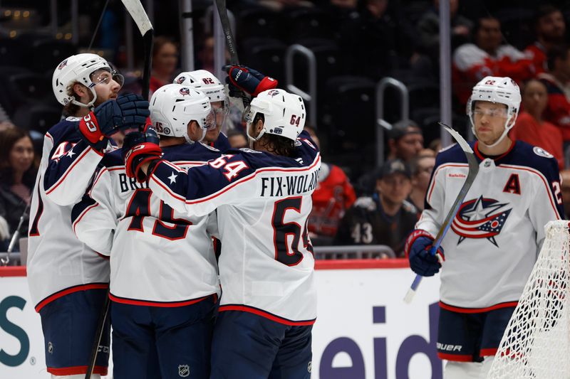 Sep 27, 2024; Washington, District of Columbia, USA; Columbus Blue Jackets left wing Mikael Pyyhtia (82) celebrates with teammates after scoring a goal against the Washington Capitals in the second period at Capital One Arena. Mandatory Credit: Geoff Burke-Imagn Images