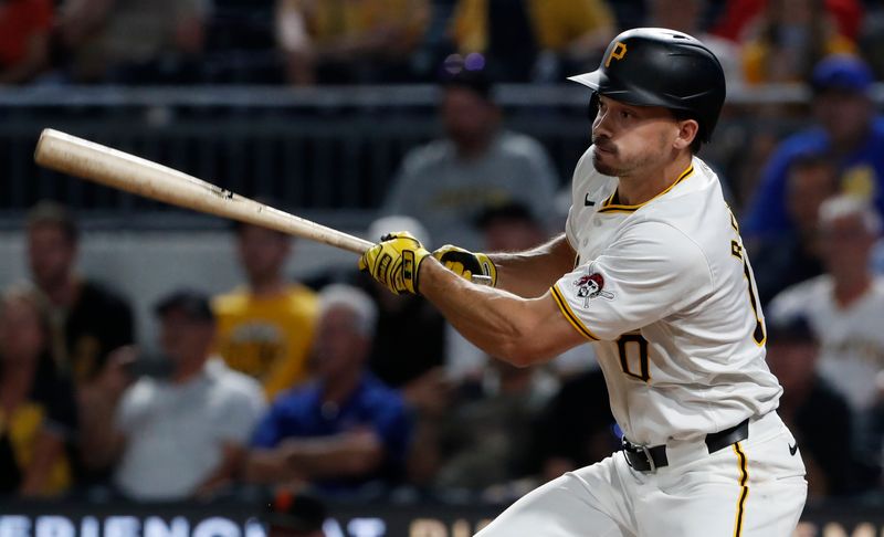 May 21, 2024; Pittsburgh, Pennsylvania, USA;  Pittsburgh Pirates right fielder Bryan Reynolds (10) drives in a run on a fielders choice against the San Francisco Giants during the ninth inning at PNC Park. Mandatory Credit: Charles LeClaire-USA TODAY Sports