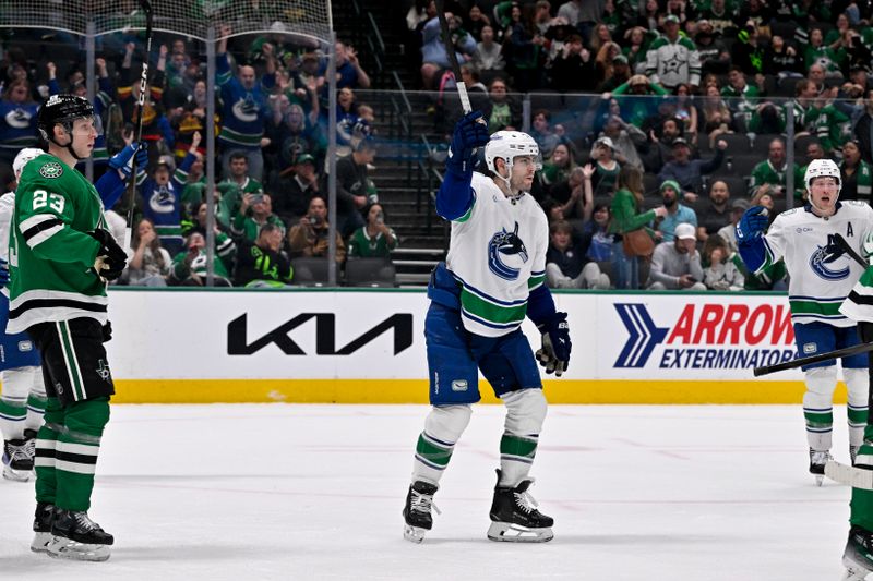 Apr 8, 2025; Dallas, Texas, USA; Vancouver Canucks left wing Jake DeBrusk (74) celebrates center Pius Suter (not pictured) scoring the game tying goal against the Dallas Stars during the third period at the American Airlines Center. Mandatory Credit: Jerome Miron-Imagn Images