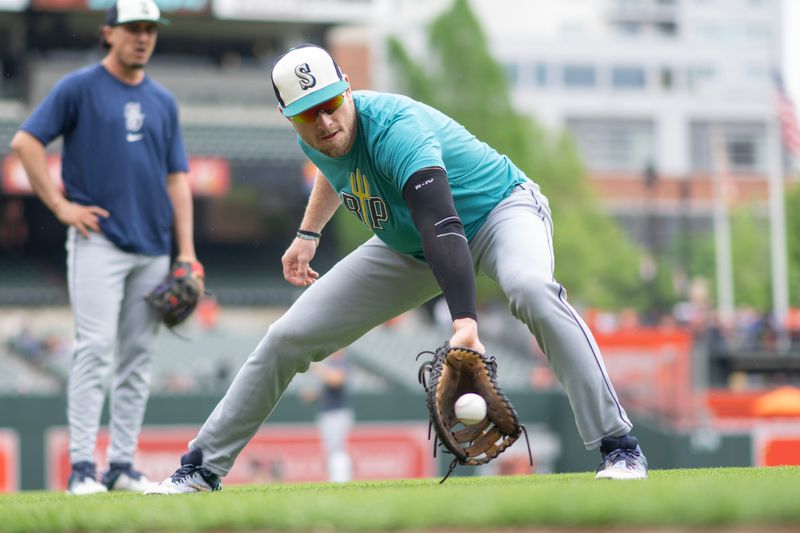 May 18, 2024; Baltimore, Maryland, USA; Seattle Mariners left fielder Luke Raley (20) takes infield practice prior to the game against the Baltimore Orioles at Oriole Park at Camden Yards. Mandatory Credit: Gregory Fisher-USA TODAY Sports