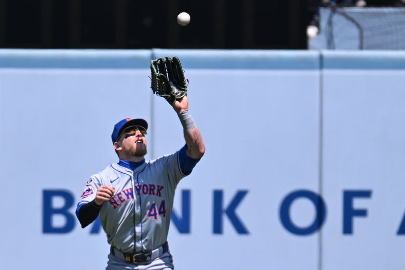 Apr 21, 2024; Los Angeles, California, USA; New York Mets outfielder Harrison Bader (44) makes a catch against the Los Angeles Dodgers during the second inning at Dodger Stadium. Mandatory Credit: Jonathan Hui-USA TODAY Sports