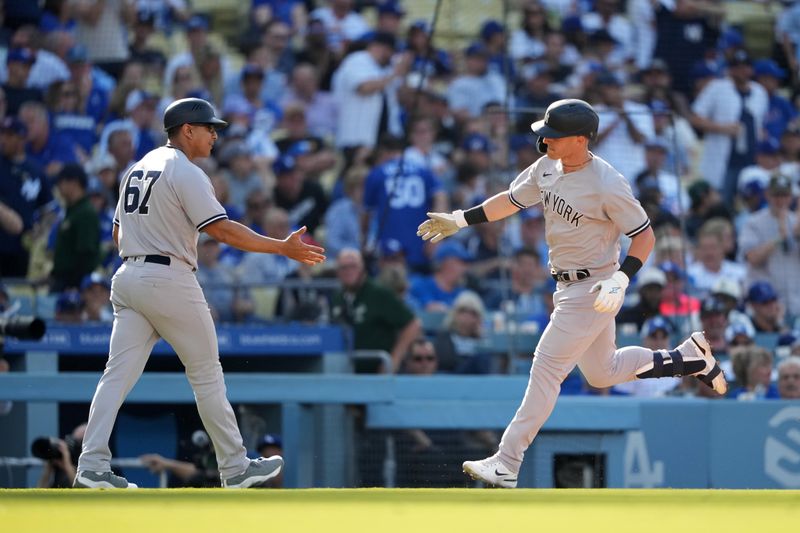 Jun 3, 2023; Los Angeles, California, USA; New York Yankees left fielder Jake Bauers (61) is congratulated by third base coach Luis Rojas (67) after hitting a home run in the fourth inning against the Los Angeles Dodgers at Dodger Stadium. Mandatory Credit: Kirby Lee-USA TODAY Sports