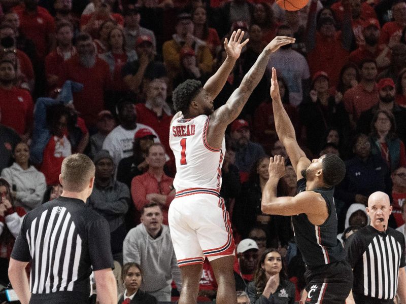 Jan 28, 2023; Houston, Texas, USA; Houston Cougars guard Jamal Shead (1) makes a three point lead against Cincinnati Bearcats guard David DeJulius (5) in the second half at Fertitta Center. Houston Cougars won 75 to 69 .Mandatory Credit: Thomas Shea-USA TODAY Sports