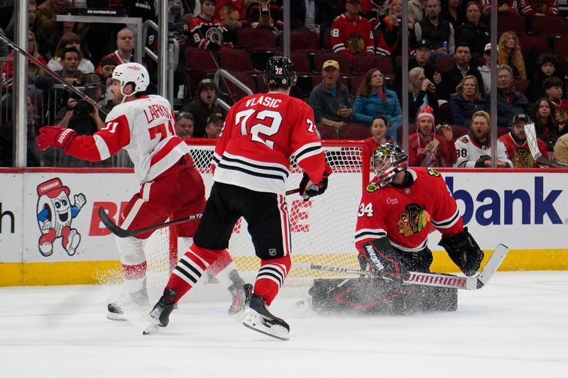 Nov 6, 2024; Chicago, Illinois, USA; Detroit Red Wings center Dylan Larkin (71) celebrates his goal on Chicago Blackhawks goaltender Petr Mrazek (34) during the second period at United Center. Mandatory Credit: David Banks-Imagn Images