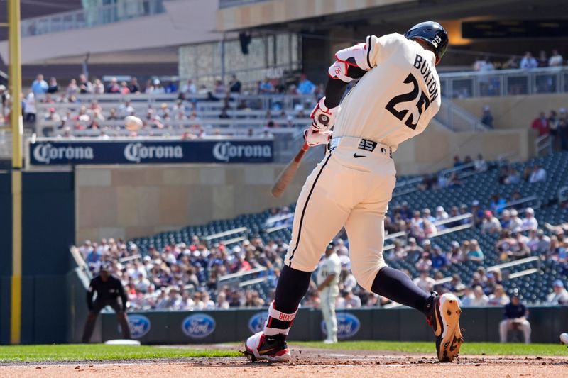 Apr 13, 2025; Minneapolis, Minnesota, USA; Minnesota Twins center fielder Byron Buxton (25) hits a solo home run against the Detroit Tigers in the first inning at Target Field. Mandatory Credit: Bruce Kluckhohn-Imagn Images
