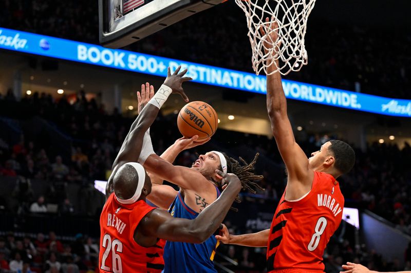 PORTLAND, OREGON - MARCH 23: Aaron Gordon #50 of the Denver Nuggets shoots against Duop Reath #26 of the Portland Trail Blazers and Kris Murray #8 during the second quarter of the game at the Moda Center on March 23, 2024 in Portland, Oregon. NOTE TO USER: User expressly acknowledges and agrees that, by downloading and or using this photograph, User is consenting to the terms and conditions of the Getty Images License Agreement. (Photo by Alika Jenner/Getty Images)