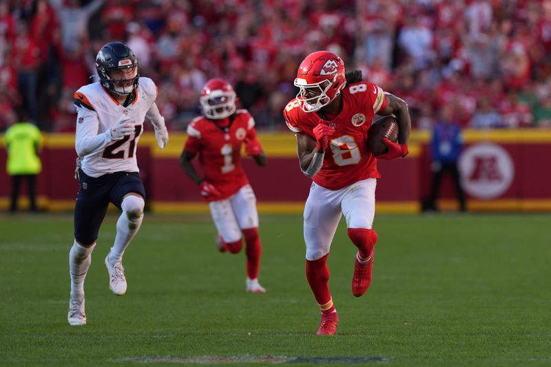 Kansas City Chiefs wide receiver DeAndre Hopkins (8) runs with the ball as Denver Broncos cornerback Riley Moss (21) defends during the second half of an NFL football game Sunday, Nov. 10, 2024, in Kansas City, Mo. (AP Photo/Charlie Riedel)