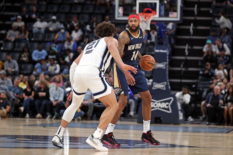 MEMPHIS, TENNESSEE - OCTOBER 25: Brandon Ingram #14 of the New Orleans Pelicans handles the ball against David Roddy #21 of the Memphis Grizzlies during the game at FedExForum on October 25, 2023 in Memphis, Tennessee. NOTE TO USER: User expressly acknowledges and agrees that, by downloading and or using this photograph, User is consenting to the terms and conditions of the Getty Images License Agreement. (Photo by Justin Ford/Getty Images)