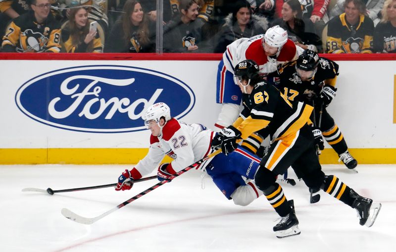 Feb 22, 2024; Pittsburgh, Pennsylvania, USA; Pittsburgh Penguins right wing Bryan Rust (17) commits a tripping penalty against Montreal Canadiens right wing Cole Caufield (22) during the second period  PPG Paints Arena. Mandatory Credit: Charles LeClaire-USA TODAY Sports