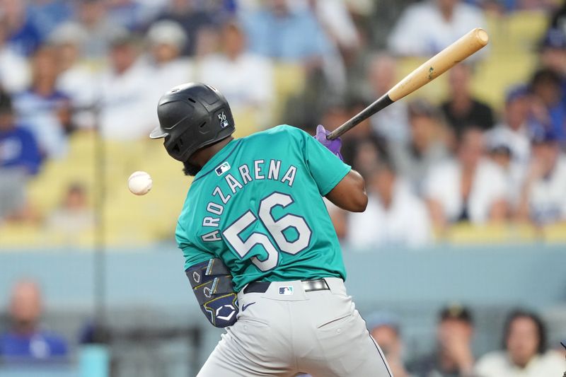 Aug 21, 2024; Los Angeles, California, USA; Seattle Mariners left fielder Randy Arozarena (56) is hit by a pitch in the second inning against the Los Angeles Dodgers at Dodger Stadium. Mandatory Credit: Kirby Lee-USA TODAY Sports