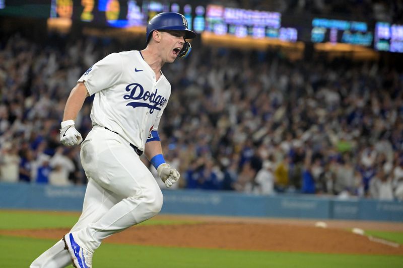 Sep 26, 2024; Los Angeles, California, USA;  Los Angeles Dodgers catcher Will Smith (16) celebrates after hitting a two-run home run off San Diego Padres starting pitcher Joe Musgrove (44) in the seventh inning at Dodger Stadium. Mandatory Credit: Jayne Kamin-Oncea-Imagn Images