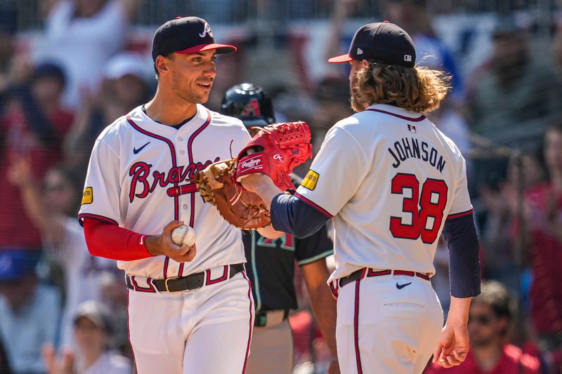 Apr 7, 2024; Cumberland, Georgia, USA; Atlanta Braves first baseman Matt Olson (28) and relief pitcher Pierce Johnson (38) react after defeating the Arizona Diamondbacks at Truist Park. Mandatory Credit: Dale Zanine-USA TODAY Sports