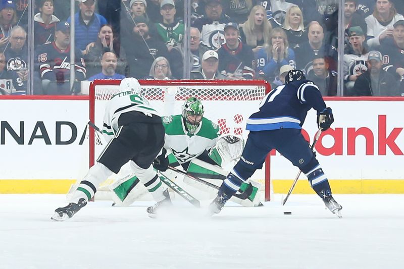 Nov 11, 2023; Winnipeg, Manitoba, CAN;  Dallas Stars goalie Scott Wedgewood (41) watches Winnipeg Jets forward Cole Perfetti (91) during the first period at Canada Life Centre. Mandatory Credit: Terrence Lee-USA TODAY Sports