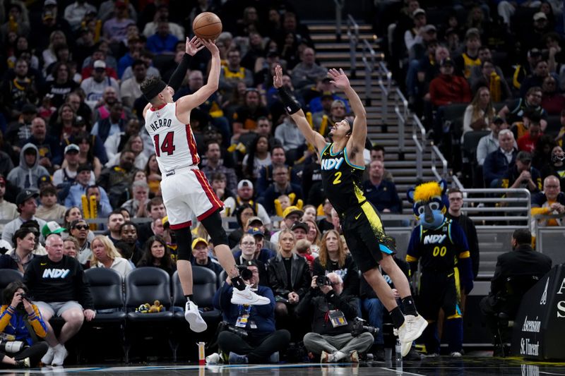 INDIANAPOLIS, INDIANA - APRIL 07: Tyler Herro #14 of the Miami Heat attempts a shot while being guarded by Andrew Nembhard #2 of the Indiana Pacers in the fourth quarter at Gainbridge Fieldhouse on April 07, 2024 in Indianapolis, Indiana. NOTE TO USER: User expressly acknowledges and agrees that, by downloading and or using this photograph, User is consenting to the terms and conditions of the Getty Images License Agreement. (Photo by Dylan Buell/Getty Images)