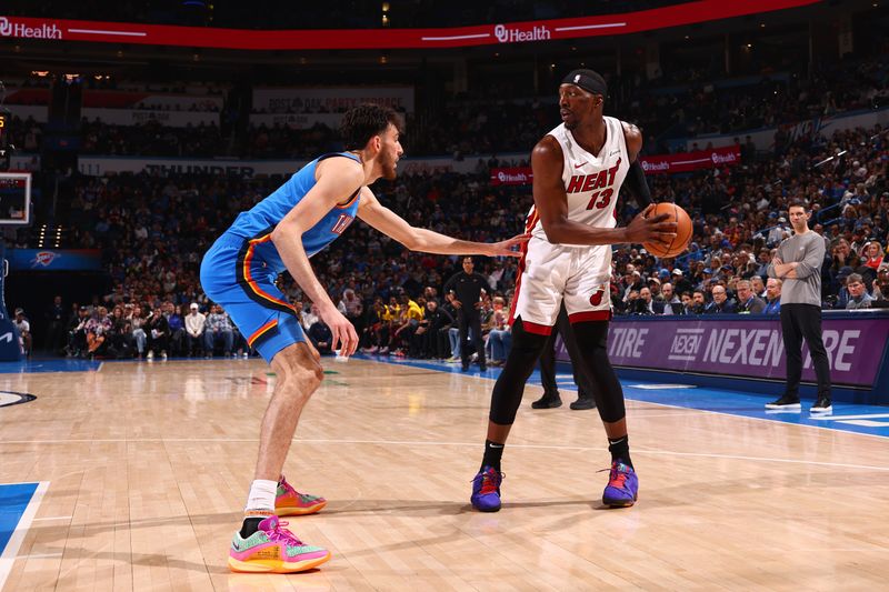 OKLAHOMA CITY, OK - MARCH 8:  Chet Holmgren #7 of the Oklahoma City Thunder plays defense against Bam Adebayo #13 of the Miami Heat on March 8, 2024 at Paycom Arena in Oklahoma City, Oklahoma. NOTE TO USER: User expressly acknowledges and agrees that, by downloading and or using this photograph, User is consenting to the terms and conditions of the Getty Images License Agreement. Mandatory Copyright Notice: Copyright 2024 NBAE (Photo by Zach Beeker/NBAE via Getty Images)