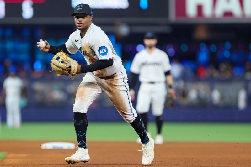 Sep 24, 2023; Miami, Florida, USA; Miami Marlins second baseman Xavier Edwards (63) tosses the baseball to first baseman Josh Bell (not pictured) and retires Milwaukee Brewers center fielder Sal Frelick (not pictured) during the fourth inning at loanDepot Park. Mandatory Credit: Sam Navarro-USA TODAY Sports