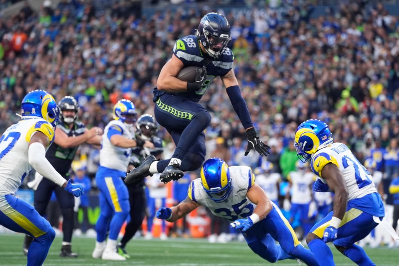 Seattle Seahawks tight end AJ Barner (88) hurdles over Los Angeles Rams linebacker Jacob Hummel (35) during the second half of an NFL football game in Seattle, Sunday, Nov. 3, 2024. (AP Photo/Lindsey Wasson)