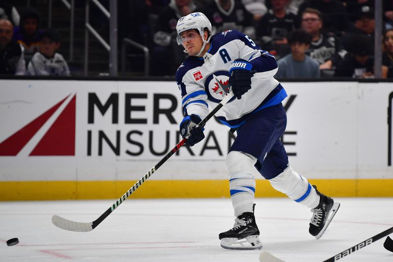 Dec 13, 2023; Los Angeles, California, USA; Winnipeg Jets center Mark Scheifele (55) shoots on goal against the Los Angeles Kings during the third period at Crypto.com Arena. Mandatory Credit: Gary A. Vasquez-USA TODAY Sports