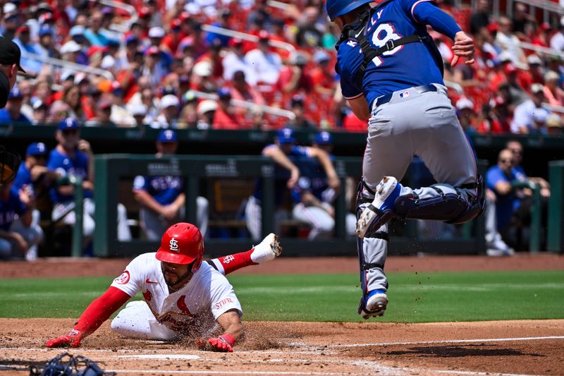 Jul 31, 2024; St. Louis, Missouri, USA;  St. Louis Cardinals right fielder Tommy Pham (29) slides safely past Texas Rangers catcher Carson Kelly (18) to score during the second inning at Busch Stadium. Mandatory Credit: Jeff Curry-USA TODAY Sports