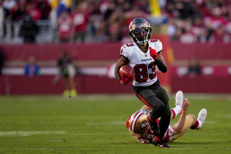 Tampa Bay Buccaneers wide receiver Deven Thompkins (83) returns a punt against the San Francisco 49ers during the second half of an NFL football game Sunday, Nov. 19, 2023, in Santa Clara, Calif. (AP Photo/Godofredo A. Vásquez)