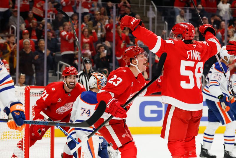 Oct 19, 2025; Detroit, Michigan, USA;  Detroit Red Wings center Emmitt Finnie (58) celebrates with left wing Lucas Raymond (23) and center Dylan Larkin (71) after scoring a goal against the Edmonton Oilers during the second period at Little Caesars Arena. Mandatory Credit: Rick Osentoski-Imagn Images
