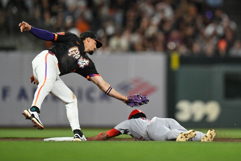 Sep 23, 2025; San Francisco, California, USA; San Francisco Giants shortstop Willy Adames (2) tags out St. Louis Cardinals center fielder Victor Scott II (11) at second during the fourth inning at Oracle Park. Mandatory Credit: Eakin Howard-Imagn Images