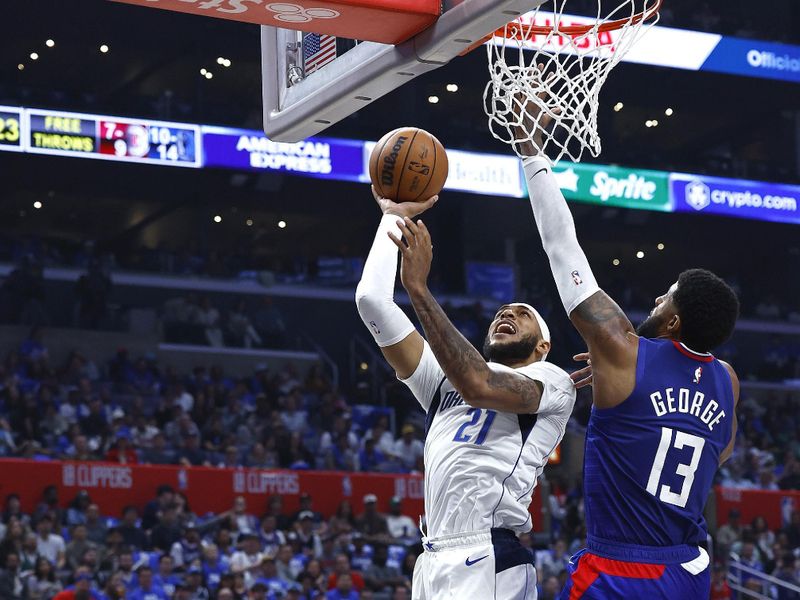 LOS ANGELES, CALIFORNIA - APRIL 21:  Daniel Gafford #21 of the Dallas Mavericks takes a shot against Paul George #13 of the LA Clippers in the second half during game one of the Western Conference First Round Playoffs at Crypto.com Arena on April 21, 2024 in Los Angeles, California.   NOTE TO USER: User expressly acknowledges and agrees that, by downloading and/or using this photograph, user is consenting to the terms and conditions of the Getty Images License Agreement.  (Photo by Ronald Martinez/Getty Images)