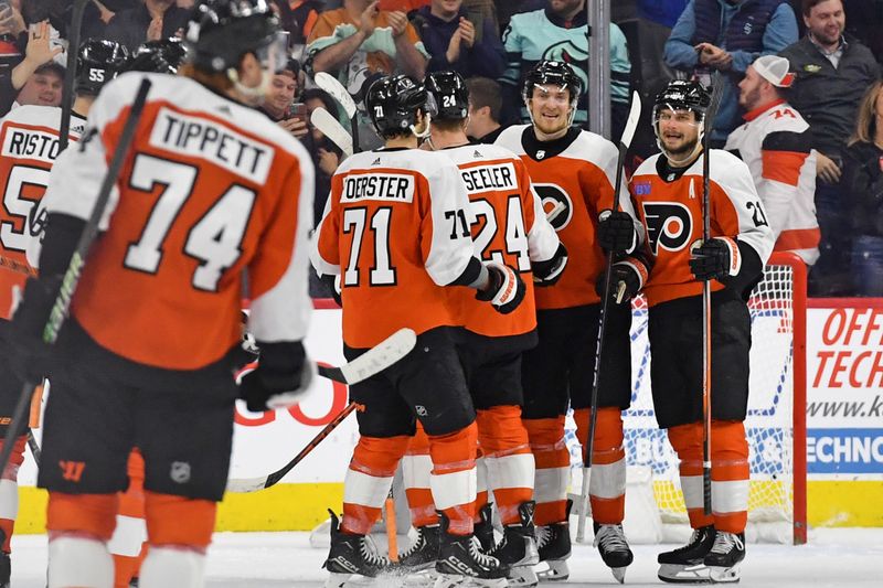 Feb 10, 2024; Philadelphia, Pennsylvania, USA; Philadelphia Flyers defenseman Travis Sanheim (6) and  center Scott Laughton (21) celebrate win against the Seattle Kraken at Wells Fargo Center. Mandatory Credit: Eric Hartline-USA TODAY Sports