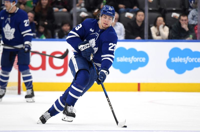 Oct 31, 2024; Toronto, Ontario, CAN;  Toronto Maple Leafs forward Matthew Knies (23) carries the puck up ice against the Seattle Kraken in the first period at Scotiabank Arena. Mandatory Credit: Dan Hamilton-Imagn Images