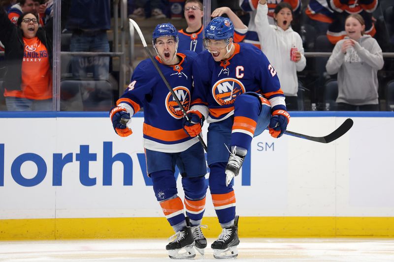 Mar 2, 2024; Elmont, New York, USA; New York Islanders left wing Anders Lee (27) celebrates his goal against the Boston Bruins with center Jean-Gabriel Pageau (44) during the second period at UBS Arena. Mandatory Credit: Brad Penner-USA TODAY Sports