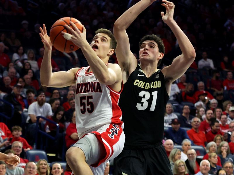 Jan 4, 2024; Tucson, Arizona, USA; Arizona Wildcats guard Conrad Martinez (55) shoots a basket against Colorado Buffaloes guard Harrison Carrington (31) during the second half at McKale Center. Mandatory Credit: Zachary BonDurant-USA TODAY Sports