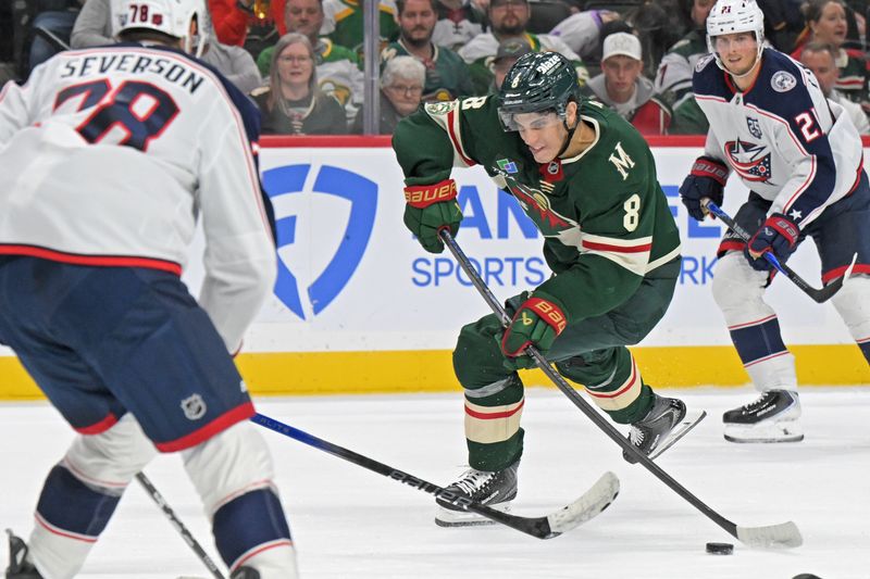 Oct 11, 2025; Saint Paul, Minnesota, USA;  Minnesota Wild defensemen Zeev Buium (8) takes a shot against the Columbus Blue Jackets during the second period at Grand Casino Arena. Mandatory Credit: Nick Wosika-Imagn Images