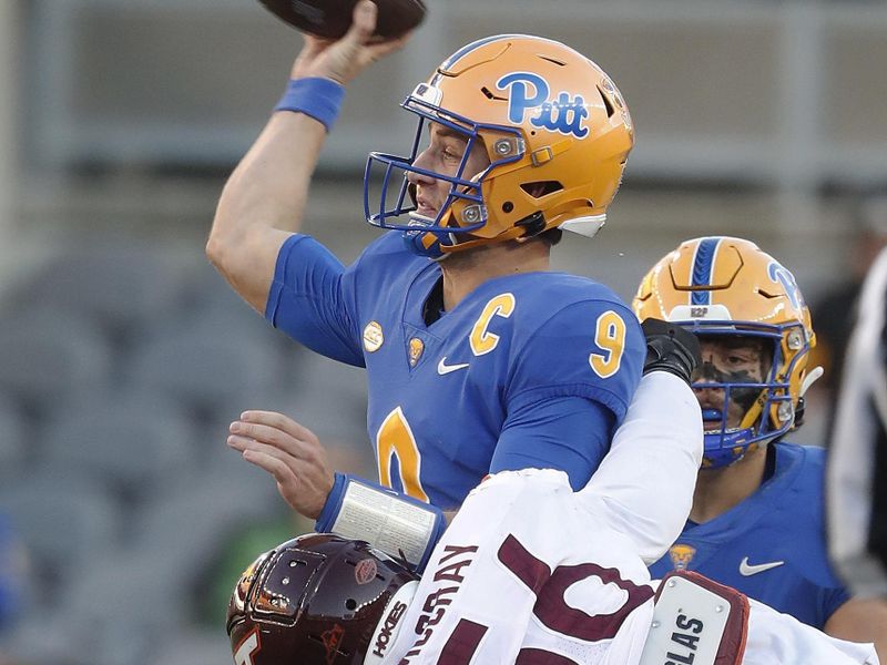 Oct 8, 2022; Pittsburgh, Pennsylvania, USA; Pittsburgh Panthers quarterback Kedon Slovis (9) passes the ball against pressure from Virginia Tech Hokies defensive lineman C.J. McCray (56) during the third quarter at Acrisure Stadium. Mandatory Credit: Charles LeClaire-USA TODAY Sports