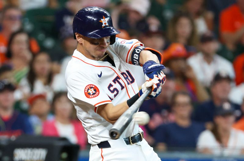 Jun 23, 2024; Houston, Texas, USA;  Houston Astros first baseman Mauricio Dubon (14) hits a RBI single against the Baltimore Orioles in the first inning at Minute Maid Park. Mandatory Credit: Thomas Shea-USA TODAY Sports