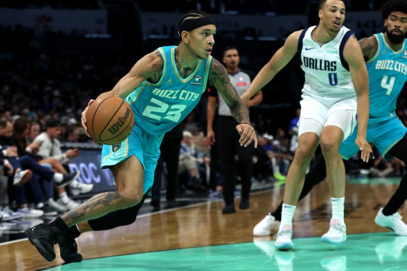 CHARLOTTE, NORTH CAROLINA - APRIL 09: Tre Mann #23 of the Charlotte Hornets drives to the basket during the first half of an NBA game against the Dallas Mavericks at Spectrum Center on April 09, 2024 in Charlotte, North Carolina. NOTE TO USER: User expressly acknowledges and agrees that, by downloading and or using this photograph, User is consenting to the terms and conditions of the Getty Images License Agreement. (Photo by David Jensen/Getty Images)