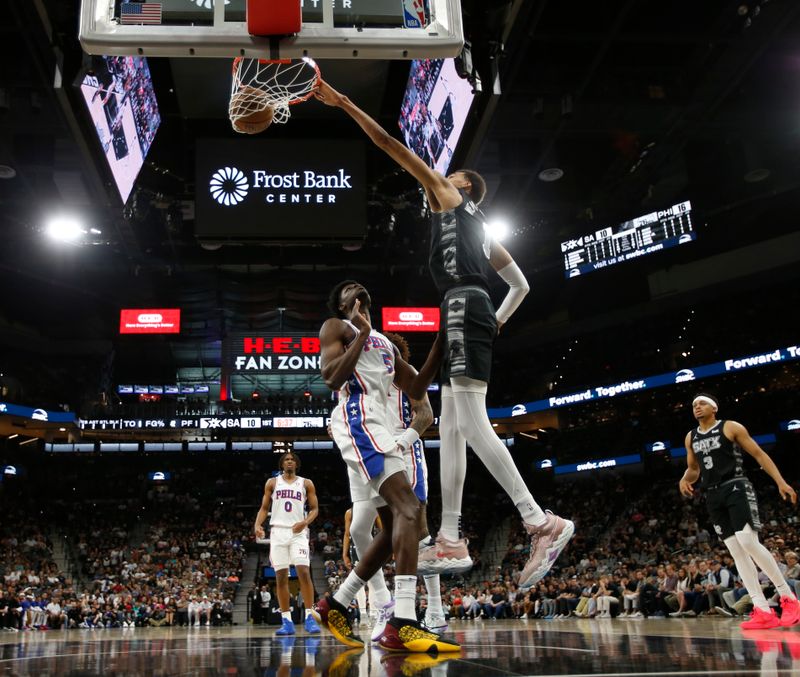 SAN ANTONIO, TX - APRIL 07: Victor Wembanyama #1 of the San Antonio Spurs dunks over Mo Bamba #5 of the Philadelphia 76ers in the first half at Frost Bank Center on April 7, 2024 in San Antonio, Texas. NOTE TO USER: User expressly acknowledges and agrees that, by downloading and or using this photograph, User is consenting to terms and conditions of the Getty Images License Agreement. (Photo by Ronald Cortes/Getty Images)