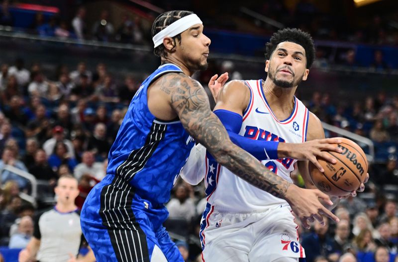 ORLANDO, FLORIDA - JANUARY 19: Tobias Harris #12 of the Philadelphia 76ers drives to the net against Chuma Okeke #3 of the Orlando Magic in the first half of a game at Kia Center on January 19, 2024 in Orlando, Florida. NOTE TO USER: User expressly acknowledges and agrees that, by downloading and or using this photograph, User is consenting to the terms and conditions of the Getty Images License Agreement. (Photo by Julio Aguilar/Getty Images)