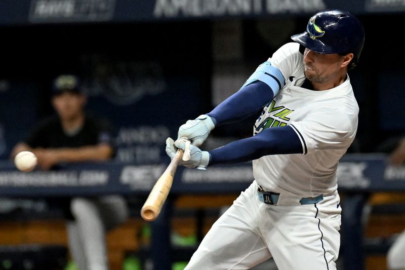 Sep 20, 2024; St. Petersburg, Florida, USA; Tampa Bay Rays right fielder Josh Lowe (15) hits a single in the second inning against the Toronto Blue Jays at Tropicana Field. Mandatory Credit: Jonathan Dyer-Imagn Images