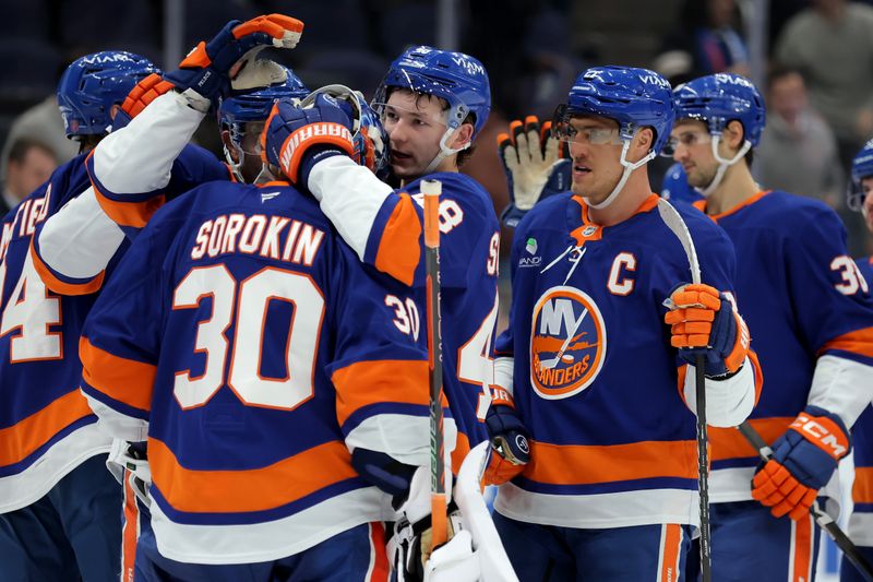Dec 2, 2025; Elmont, New York, USA; New York Islanders goaltender Ilya Sorokin (30) celebrates with defenseman Matthew Schaefer (48) and left wing Anders Lee (27) after defeating the Tampa Bay Lightning at UBS Arena. Mandatory Credit: Brad Penner-Imagn Images