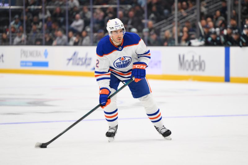 Oct 2, 2024; Seattle, Washington, USA; Edmonton Oilers defenseman Evan Bouchard (2) plays the puck during the second period against the Seattle Kraken at Climate Pledge Arena. Mandatory Credit: Steven Bisig-Imagn Images