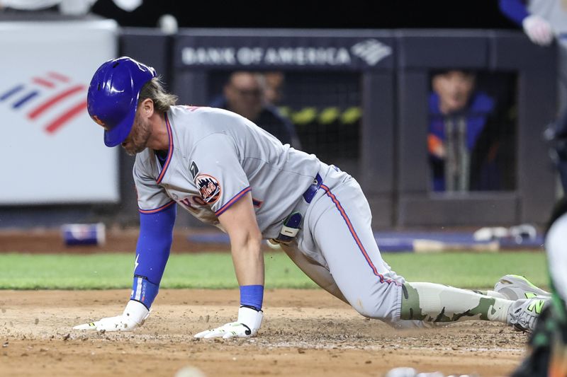 May 18, 2025; Bronx, New York, USA;  New York Mets center fielder Jeff McNeil (1) slides safely at home to score the tying run in the fifth inning against the New York Yankees at Yankee Stadium. Mandatory Credit: Wendell Cruz-Imagn Images