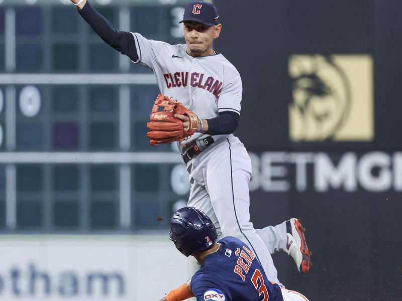 Aug 1, 2023; Houston, Texas, USA; Houston Astros shortstop Jeremy Pena (3) is out at second base as Cleveland Guardians second baseman Andres Gimenez (0) throws to first base during the fifth inning at Minute Maid Park. Mandatory Credit: Troy Taormina-USA TODAY Sports