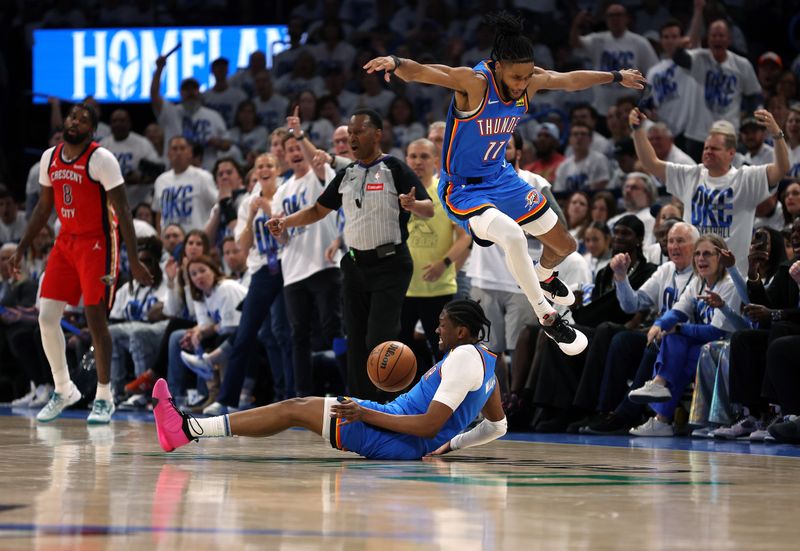 OKLAHOMA CITY, OKLAHOMA - APRIL 24:  Isaiah Joe #11 of the Oklahoma City Thunder leaps over Jalen Williams #8 while competing for a loose ball during game two of the first round of the NBA playoffs against the New Orleans Pelicans at Paycom Center on April 24, 2024 in Oklahoma City, Oklahoma. (Photo by Jamie Squire/Getty Images)