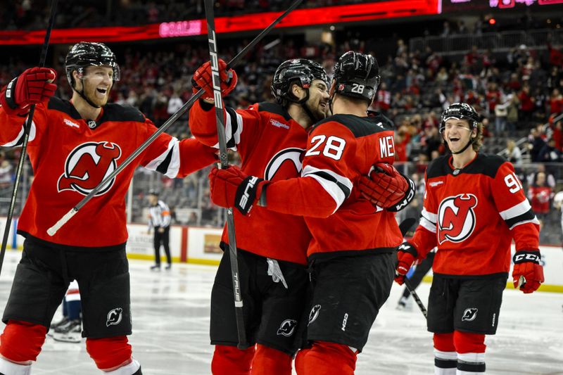 Oct 19, 2024; Newark, New Jersey, USA; New Jersey Devils center Nico Hischier (13) celebrates with teammates after scoring a goal against the Washington Capitals during the second period at Prudential Center. Mandatory Credit: John Jones-Imagn Images