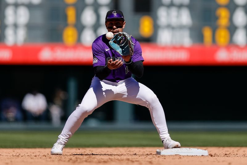 Apr 7, 2024; Denver, Colorado, USA; Colorado Rockies second baseman Alan Trejo (13) catches the ball and turns the first half of a double play in the sixth inning against the Tampa Bay Rays at Coors Field. Mandatory Credit: Isaiah J. Downing-USA TODAY Sports