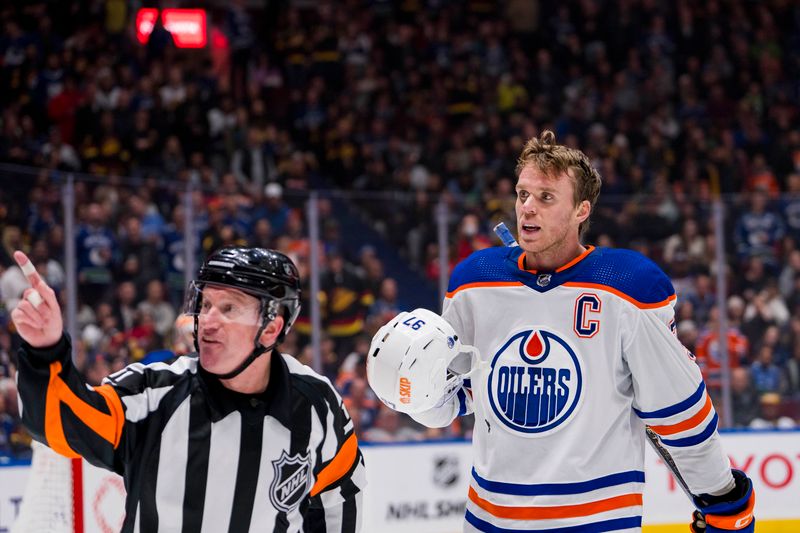 Nov 6, 2023; Vancouver, British Columbia, CAN; Edmonton Oilers forward Connor McDavid (97) reacts to referee Kelly Sutherland calling a penalty in a game against the Vancouver Canucks in the third period at Rogers Arena. Mandatory Credit: Bob Frid-USA TODAY Sports